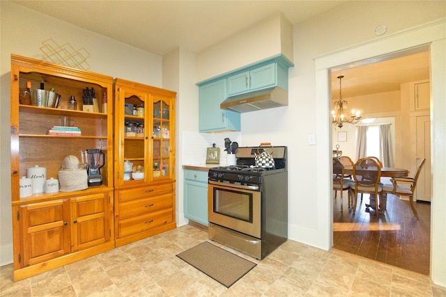 kitchen featuring pendant lighting, a notable chandelier, and stainless steel gas range