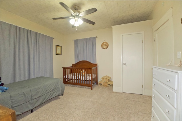 bedroom featuring ceiling fan and light colored carpet