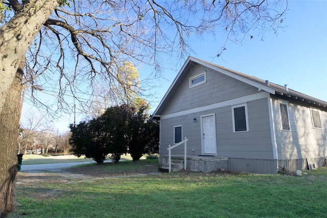 back of property with a lawn