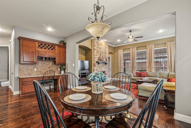 dining area featuring ceiling fan and dark hardwood / wood-style floors