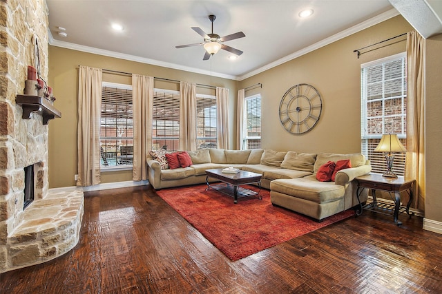 living room with a stone fireplace, crown molding, and dark hardwood / wood-style flooring