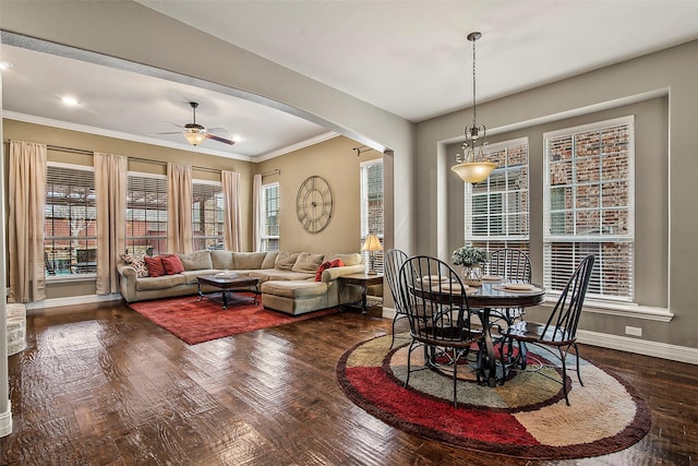 dining room featuring ceiling fan, dark hardwood / wood-style flooring, and crown molding