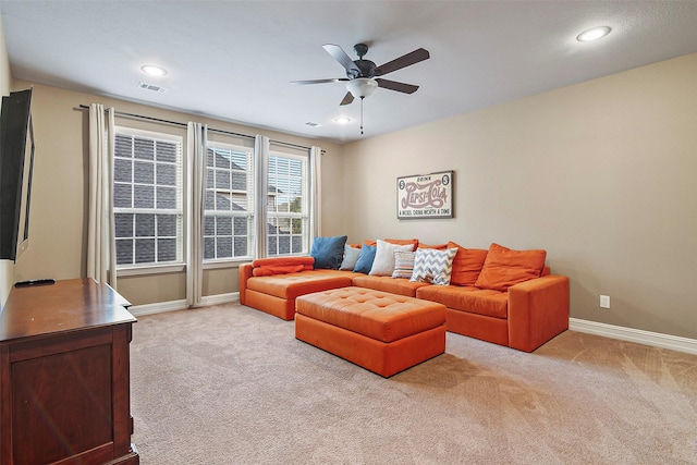 living room with light colored carpet and ceiling fan