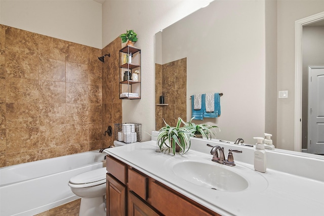 full bathroom with toilet, vanity, and tiled shower / bath