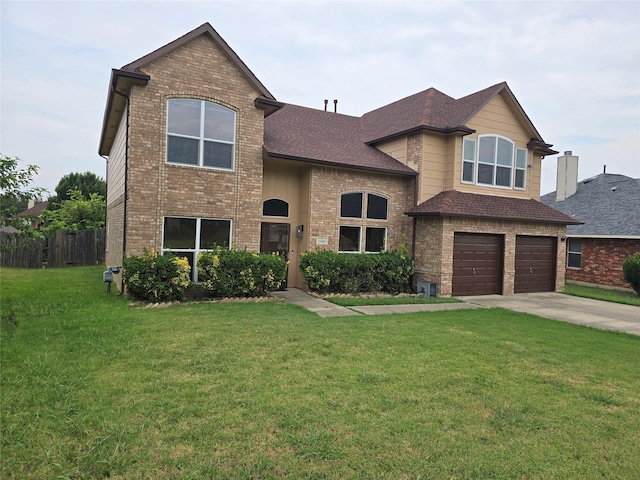 view of front of house with a garage and a front lawn