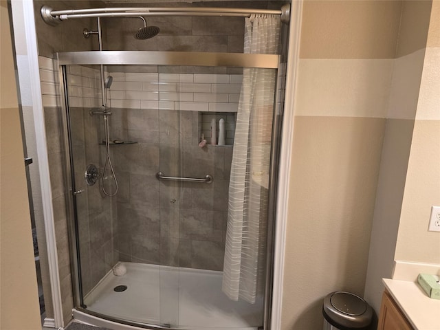 bathroom with an enclosed shower and vanity