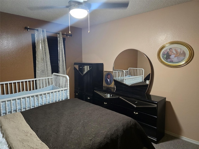 bedroom featuring ceiling fan, a textured ceiling, and carpet floors