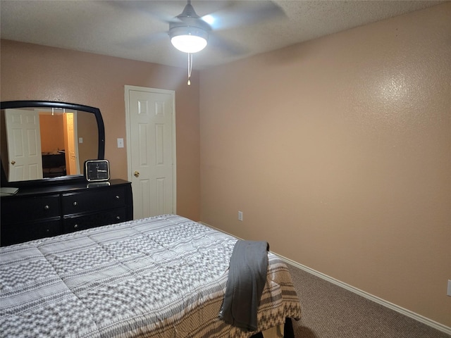 bedroom featuring ceiling fan and carpet