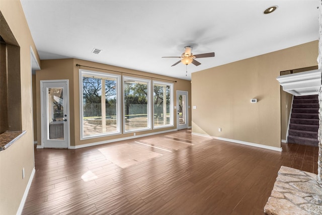 unfurnished living room with dark hardwood / wood-style floors and ceiling fan