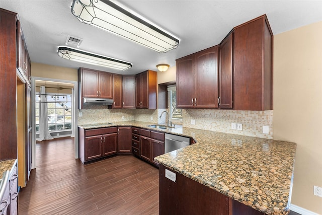 kitchen featuring sink, dishwasher, backsplash, dark hardwood / wood-style floors, and light stone counters