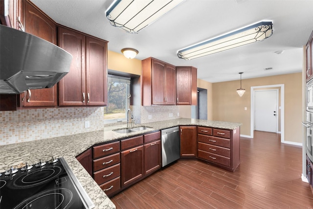 kitchen featuring ventilation hood, dishwasher, stovetop, hanging light fixtures, and kitchen peninsula