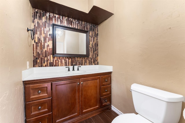 bathroom featuring vanity, hardwood / wood-style floors, and toilet