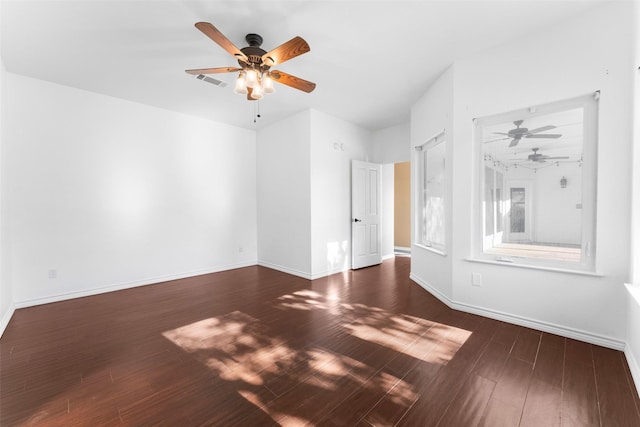 spare room with dark hardwood / wood-style floors and ceiling fan