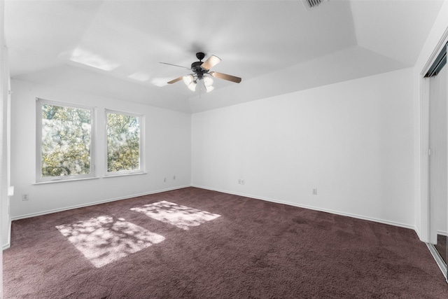 unfurnished room featuring vaulted ceiling, ceiling fan, and dark colored carpet