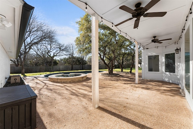 view of patio with an in ground hot tub