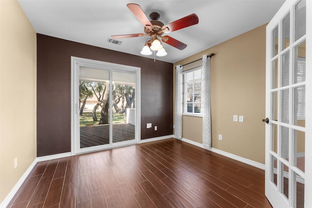 unfurnished room featuring ceiling fan and dark hardwood / wood-style flooring