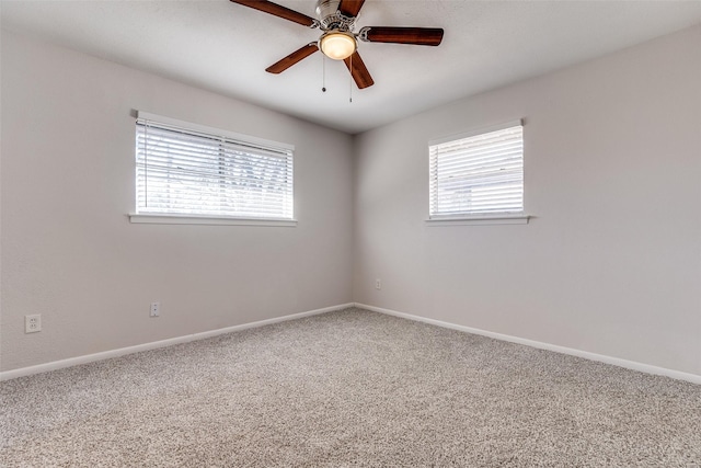 spare room featuring ceiling fan and carpet