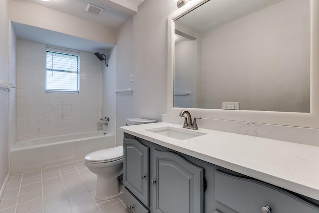 full bathroom with tile patterned floors, toilet, vanity, and tiled shower / bath