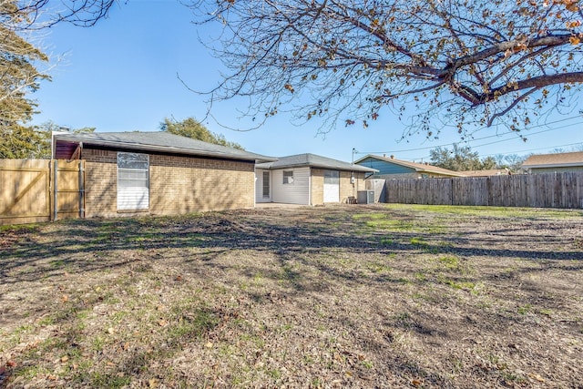 rear view of property with a yard