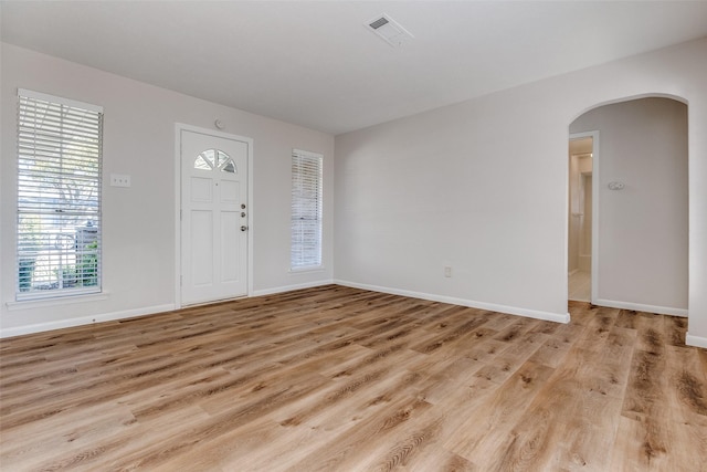 entryway featuring plenty of natural light and light hardwood / wood-style flooring