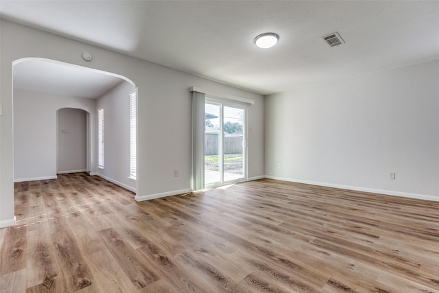 empty room with light hardwood / wood-style flooring