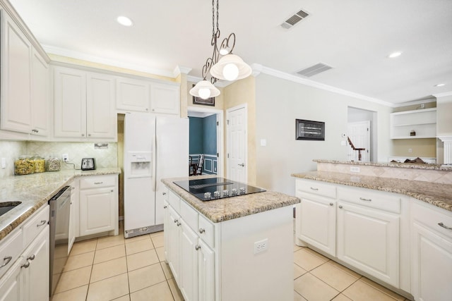 kitchen with a kitchen island, white cabinets, and white refrigerator with ice dispenser