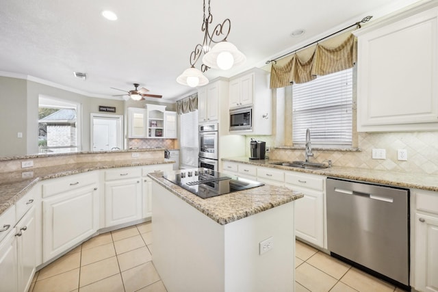 kitchen with sink, a kitchen island, white cabinetry, and stainless steel appliances