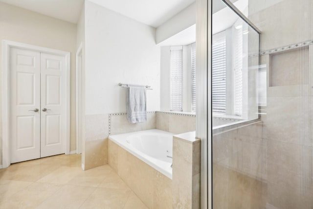 bathroom with tile patterned flooring and plus walk in shower