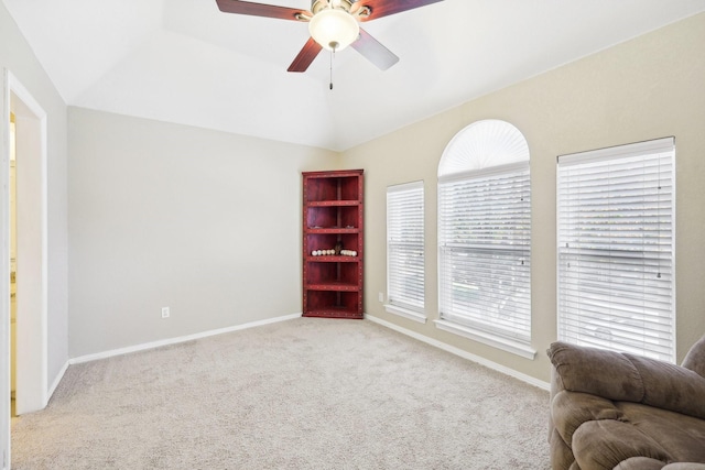 sitting room featuring ceiling fan, light colored carpet, and lofted ceiling