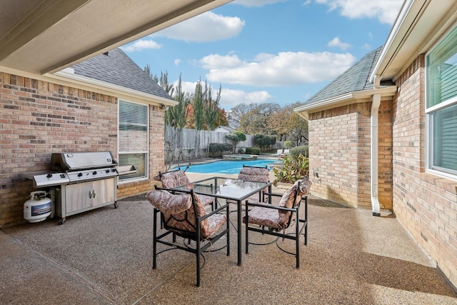 view of patio featuring a fenced in pool and grilling area