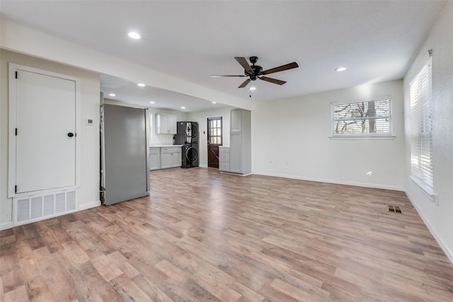 unfurnished living room with ceiling fan and light wood-type flooring