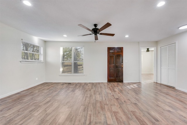 empty room with light hardwood / wood-style floors and ceiling fan