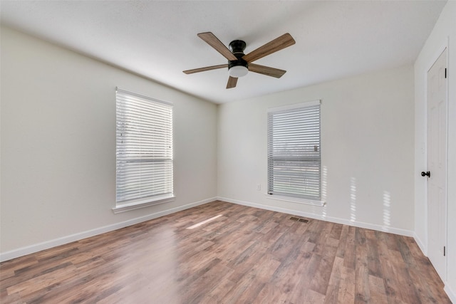 spare room with wood-type flooring and ceiling fan