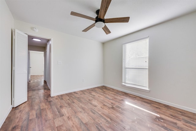 spare room with ceiling fan and hardwood / wood-style floors