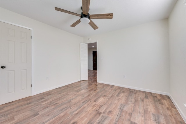 empty room featuring light wood-type flooring and ceiling fan