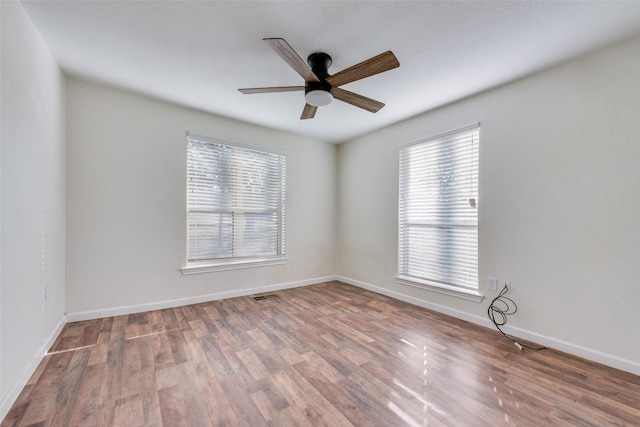 unfurnished room with hardwood / wood-style floors and ceiling fan