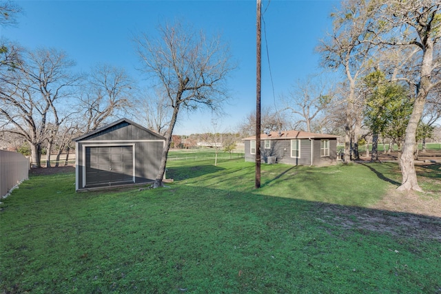 view of yard featuring a garage and an outdoor structure