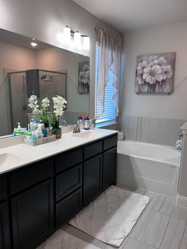 bathroom with separate shower and tub and vanity