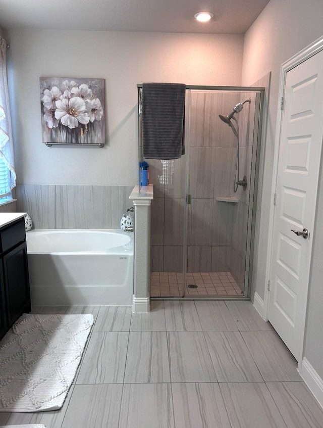 bathroom featuring vanity and plus walk in shower