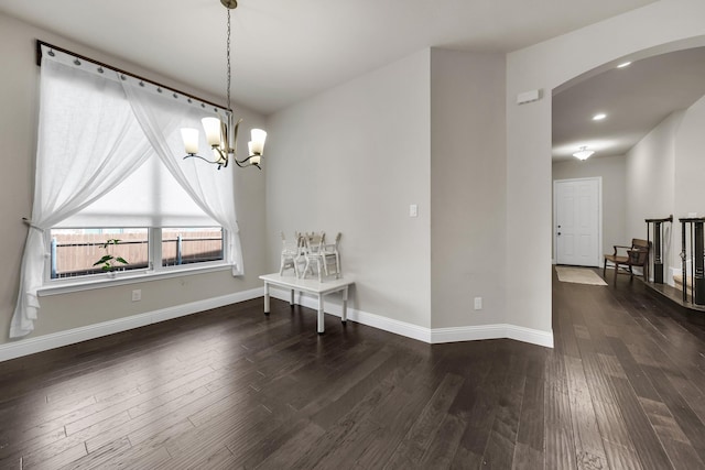 dining room with an inviting chandelier and dark hardwood / wood-style flooring