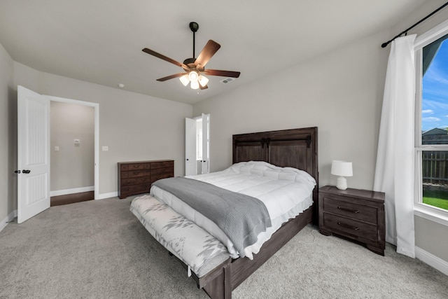 bedroom with ceiling fan and light colored carpet