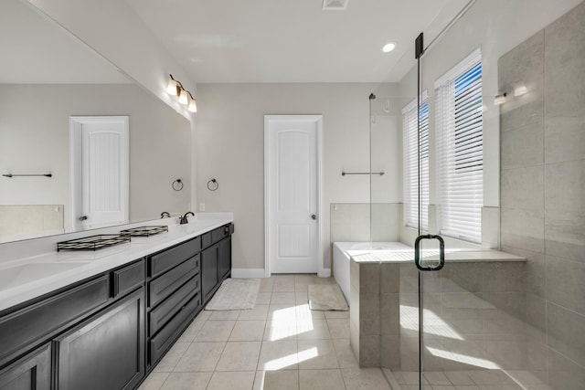 bathroom featuring vanity, a shower with door, and tile patterned flooring