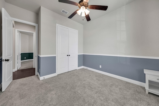 unfurnished bedroom featuring a closet, ceiling fan, and carpet flooring