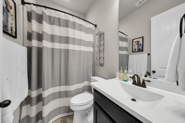 bathroom featuring toilet and vanity