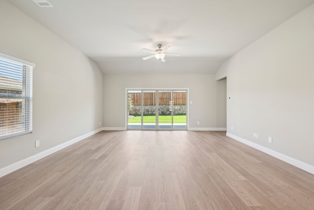 unfurnished room with vaulted ceiling, light hardwood / wood-style floors, and ceiling fan