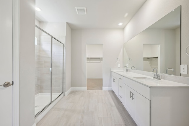 bathroom featuring vanity and a shower with door