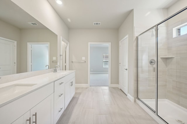 bathroom featuring an enclosed shower and vanity