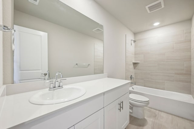 full bathroom featuring vanity, toilet, and tiled shower / bath