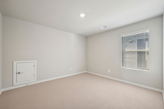 unfurnished room featuring light carpet