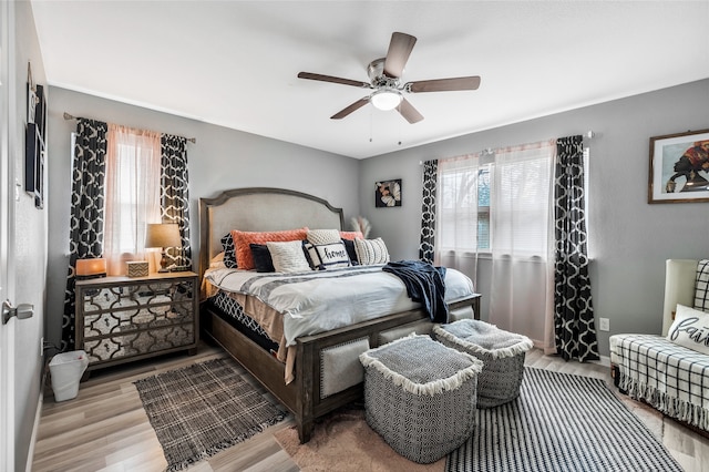 bedroom with ceiling fan and light wood-type flooring